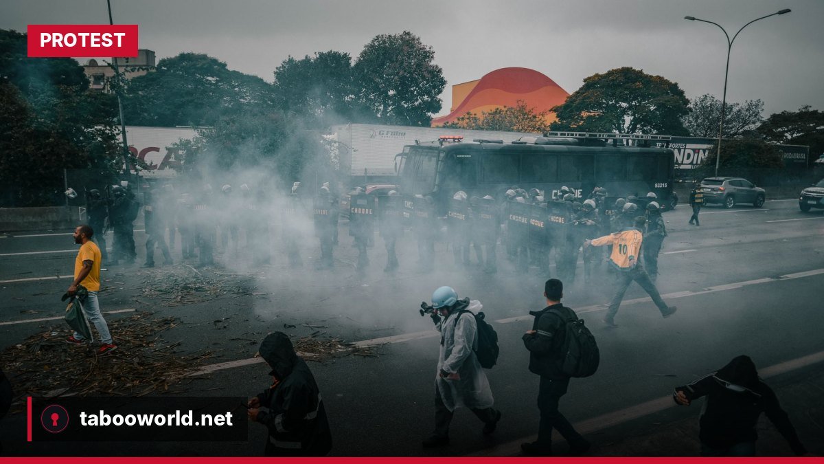 Police fire tear‑gas canisters at demonstrators on a Paris street during the October 2026 protests.