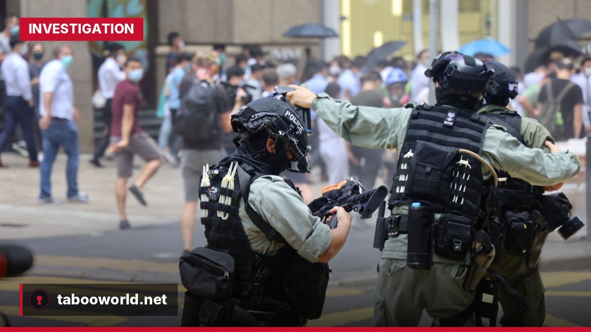 Police officers handling a stun grenade during French student protests